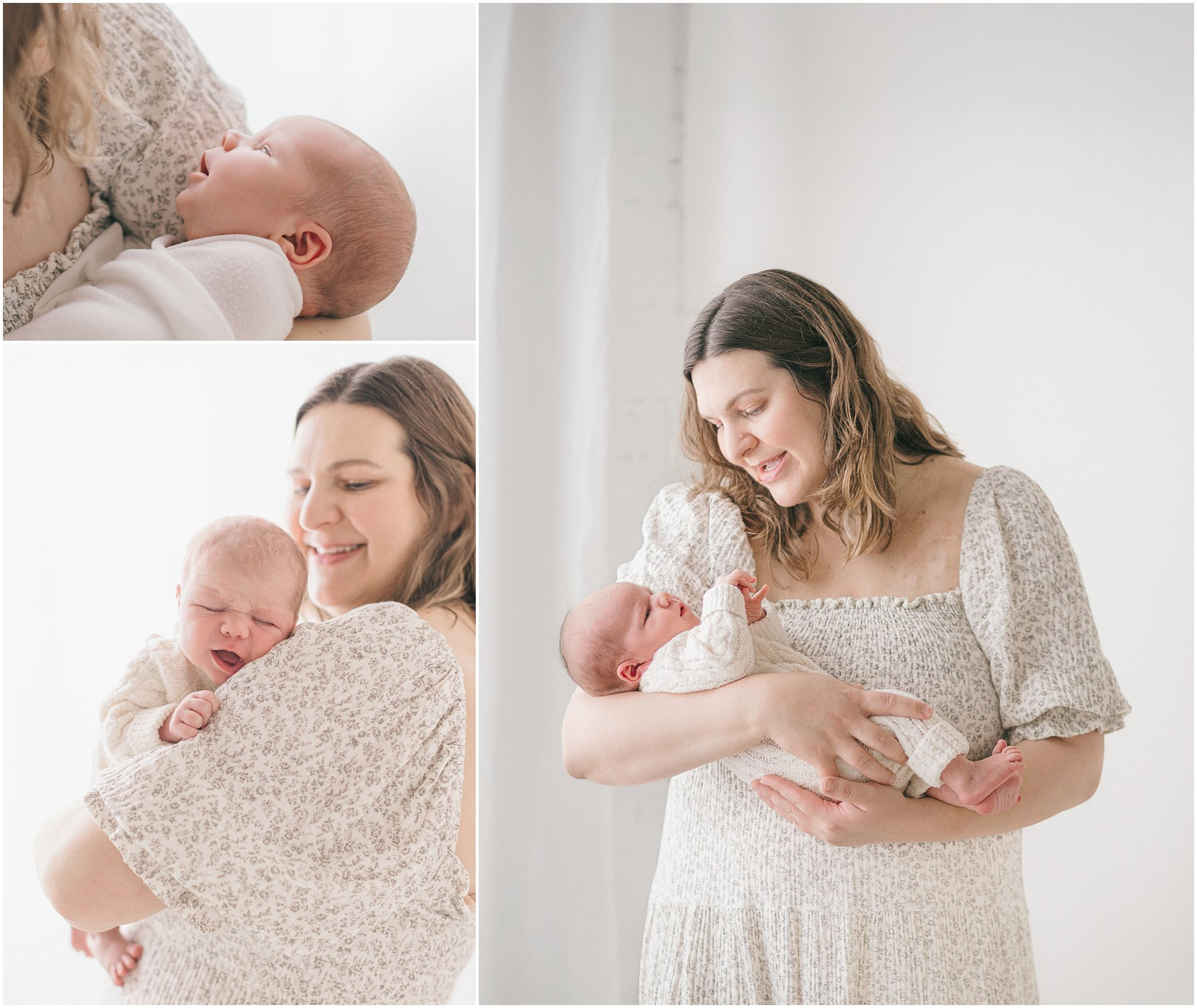 Mother holds a newborn baby, both smiling, in a bright, softly lit setting.