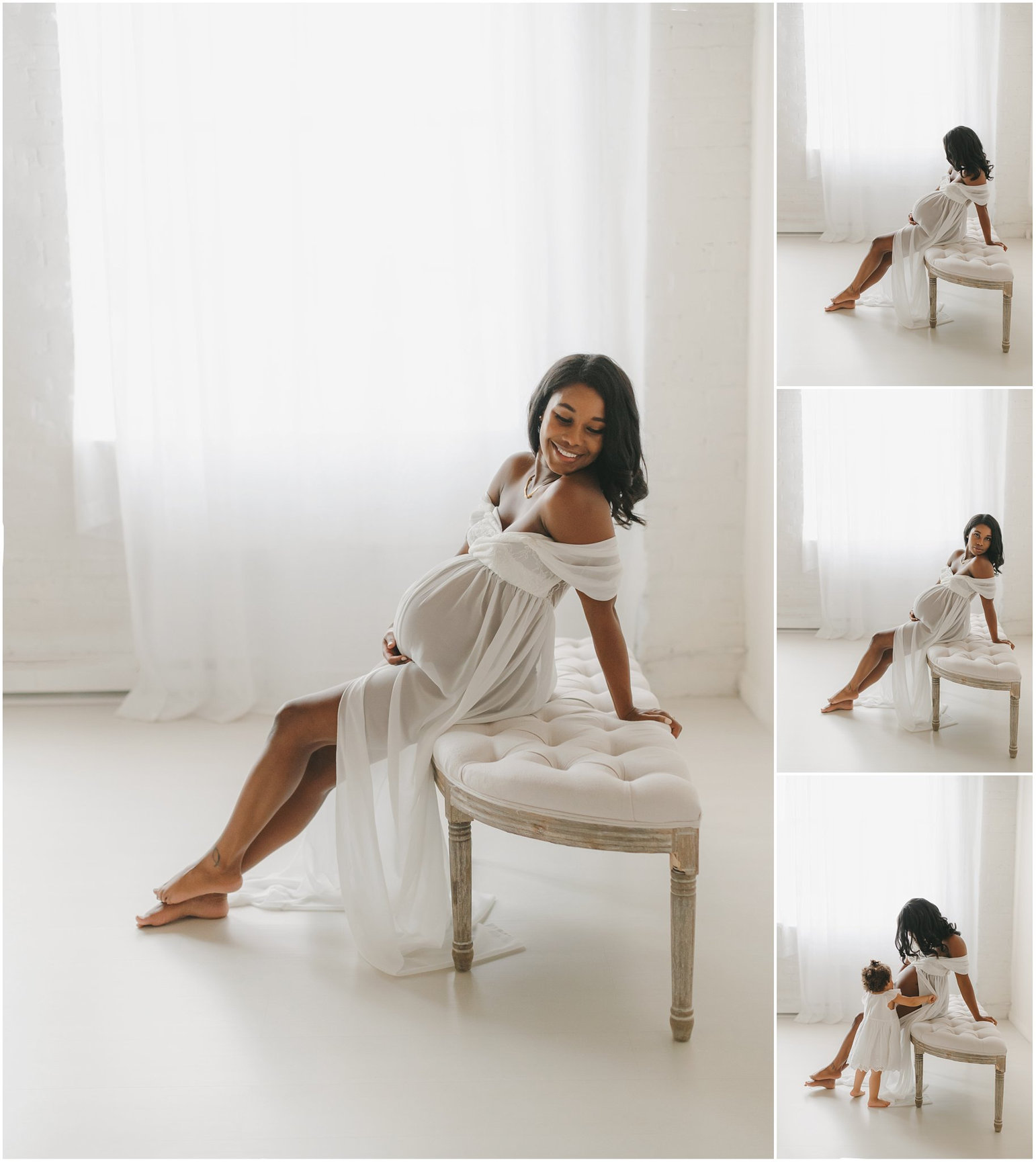 Pregnant woman in a flowing white dress seated on a stool, captured in a bright, softly lit room.