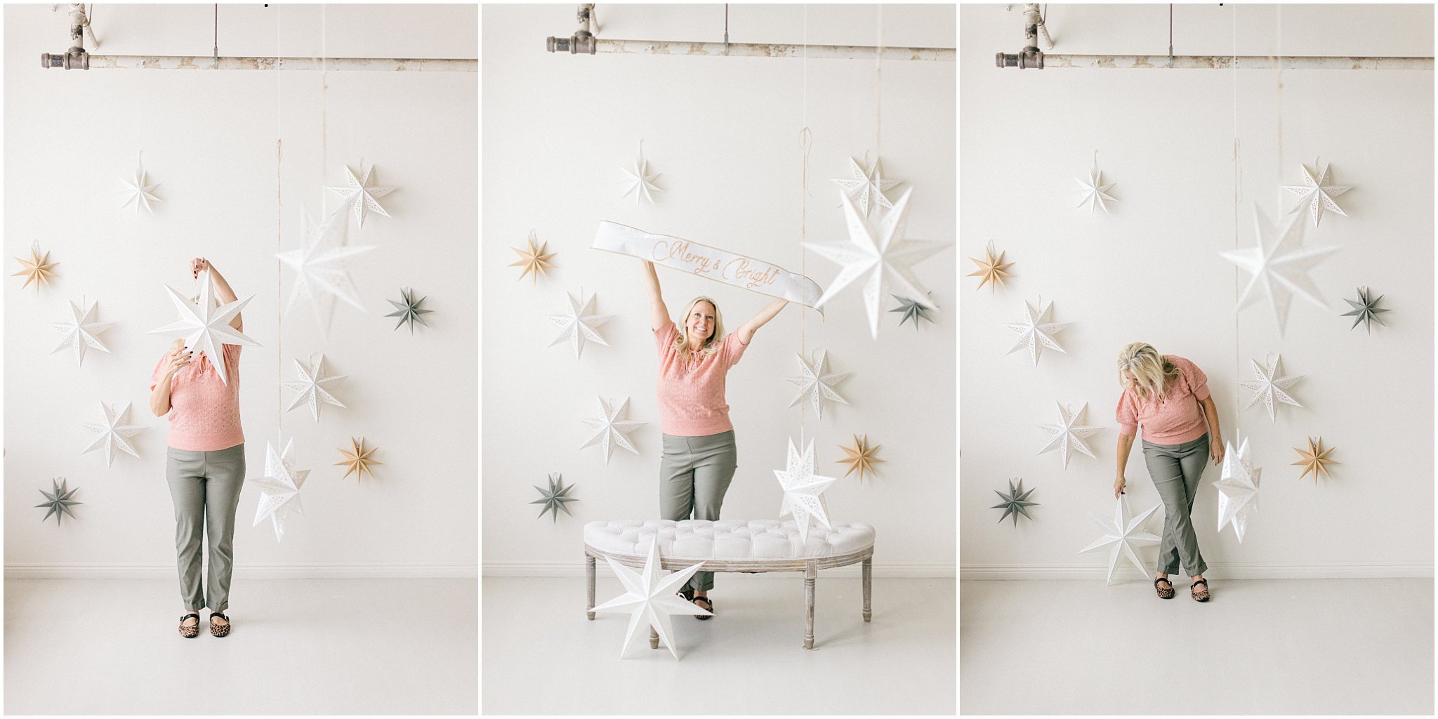 A woman poses playfully in a studio with paper decorations against a white background.
