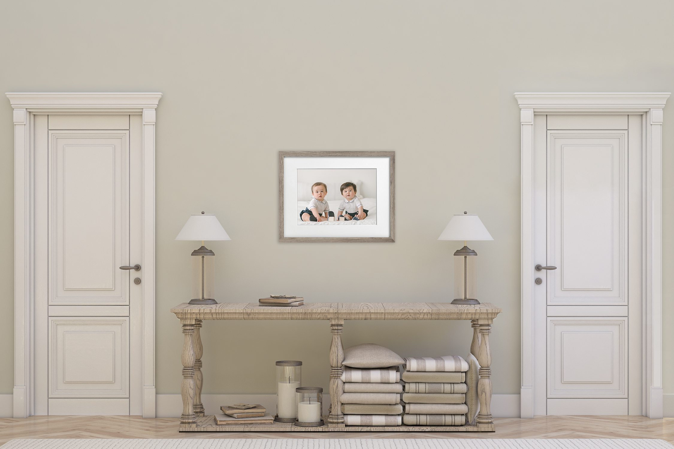 Interior scene featuring two white doors, a console table with lamps, and a framed photo on the wall.