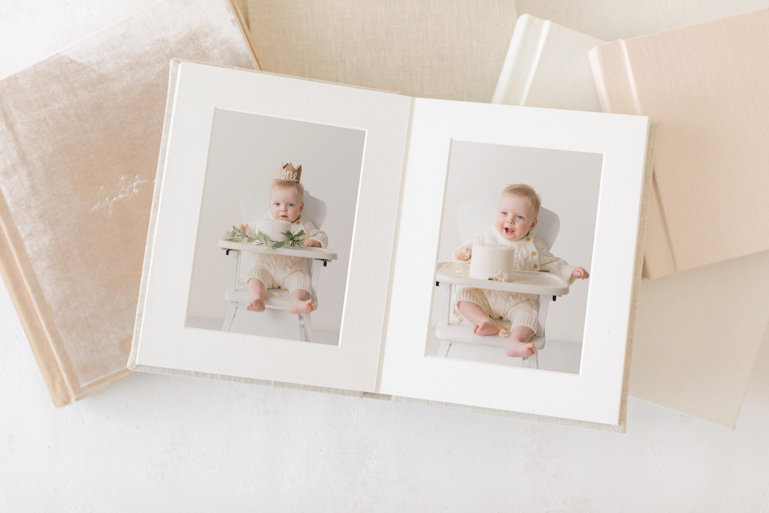 Two adorable baby photos in a white frame, set against a neutral background with soft textures.