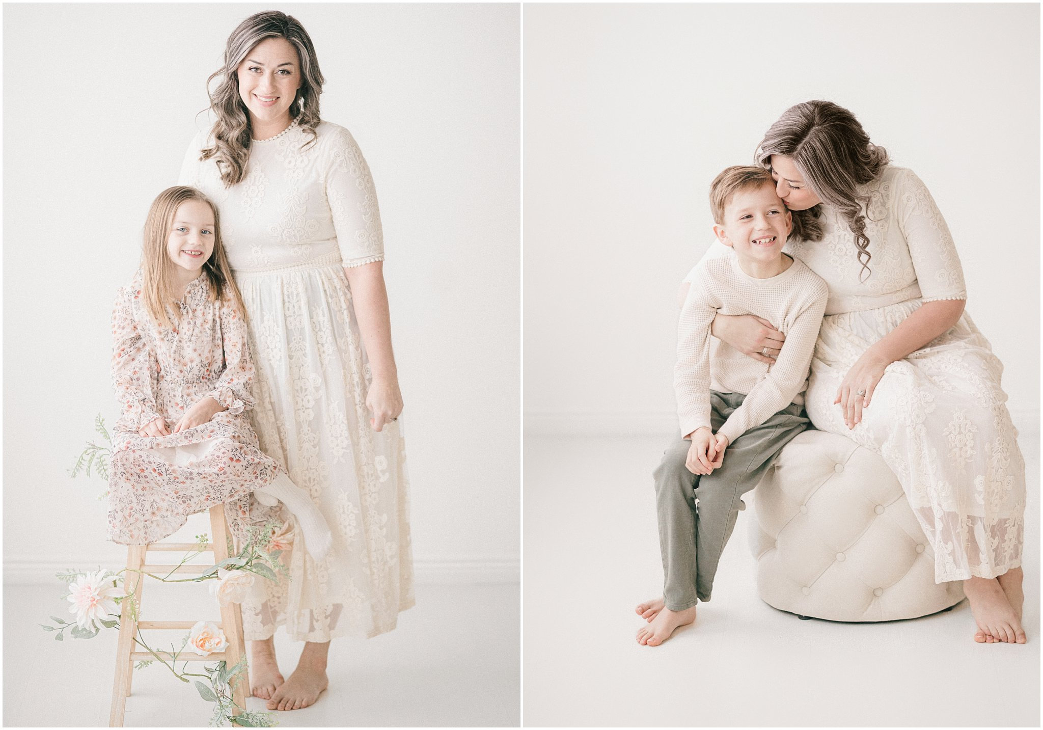 A mother and child in light dresses sitting and posing together against a white background.