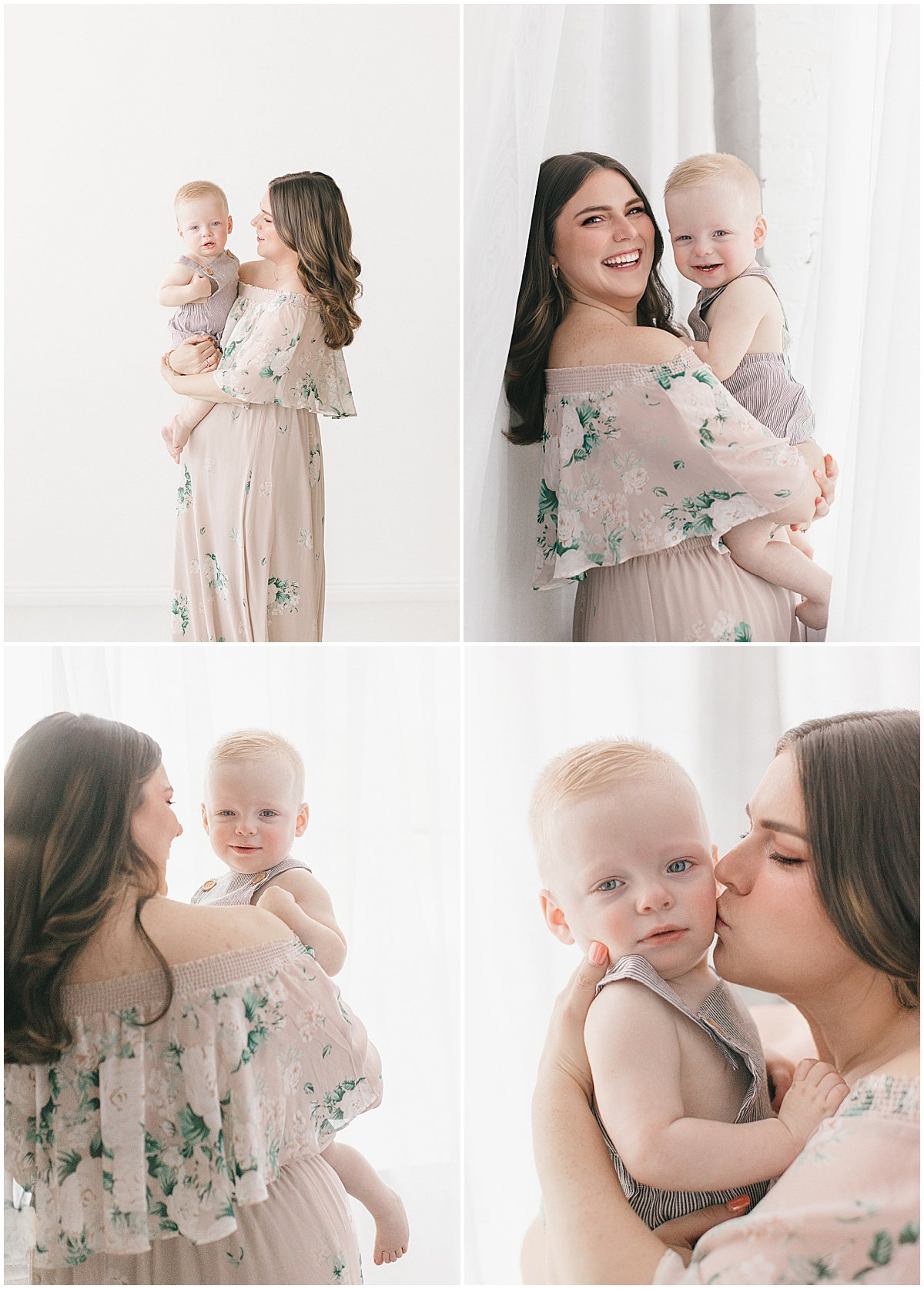 A woman in a floral dress holds a baby, posing for photos against a white curtain backdrop.