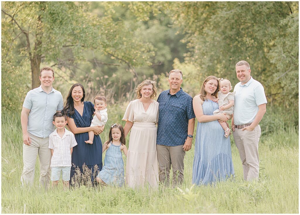 Family Photos in Greenfield at Pixel Dust Acres with an extended family standing together in soft summer greenery