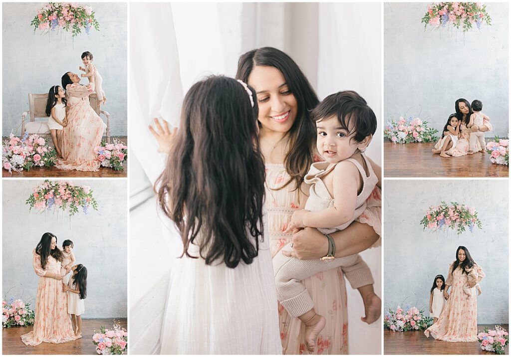 Twin Cities motherhood photos of a mom holding her baby while her daughter sits beside them in a NE Minneapolis studio