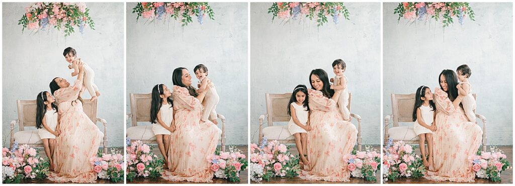 Studio motherhood session in Minneapolis with a mother laughing and playing with her baby and daughter