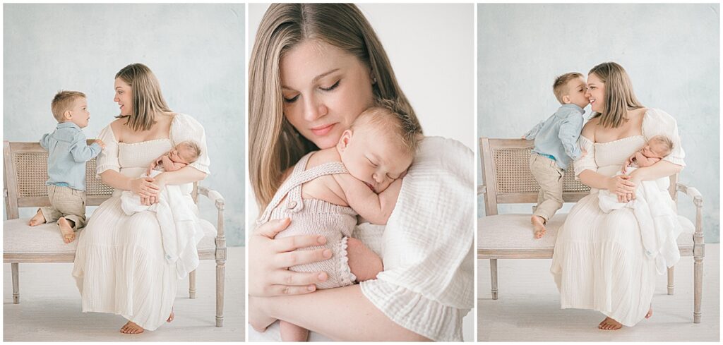 Mother holding her sleeping newborn while her older son talks to her and gives her a kiss during a studio session.