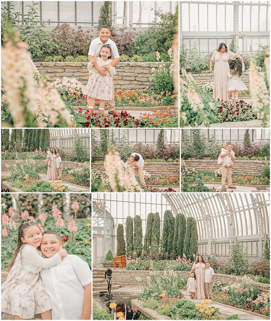 Mother and two children laughing and playing among flowers in a bright conservatory.