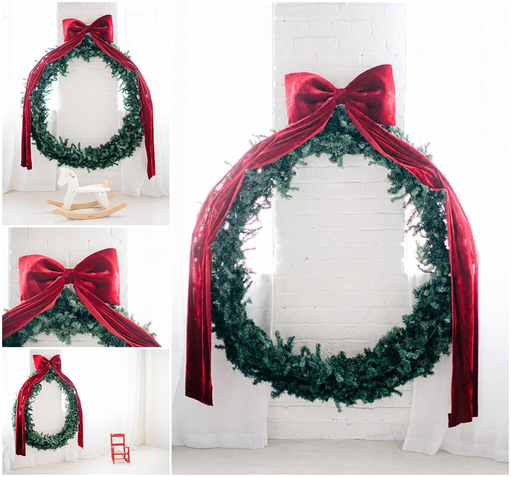 Oversized Christmas wreath with a red velvet bow and rocking horse in a bright Minneapolis photography studio.