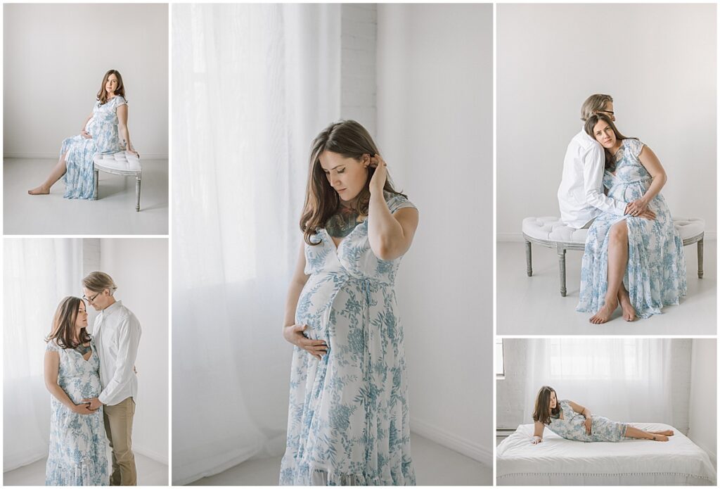 Pregnant woman in a blue floral dress posing with her partner in a studio maternity session.