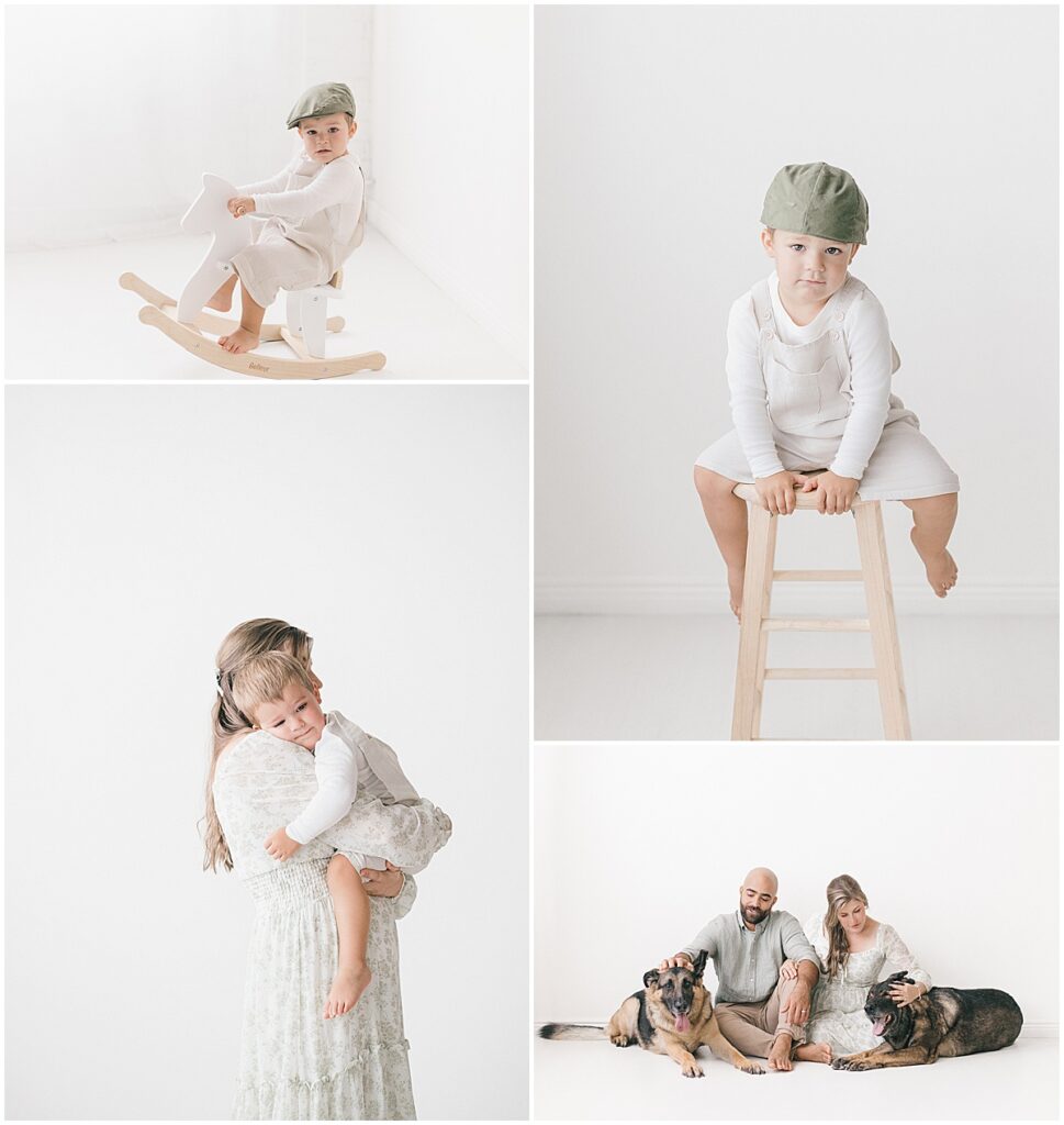 Toddler in a green cap on a rocking horse and a tall stool, plus parents sitting on the floor with their two German Shepherds